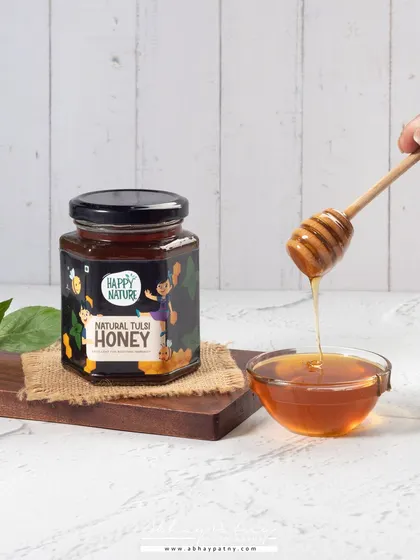 Capturing the perfect honey drip requires patience and the right lighting. This shot highlights the viscosity and clarity of the honey, which are key indicators of its quality and purity.