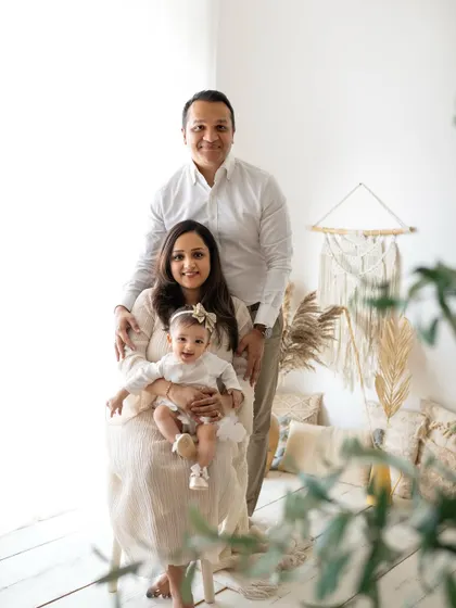 A lovely family portrait in my studio's boho corner. The neutral tones and natural textures create a warm and inviting atmosphere for this family of three.