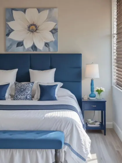 This contemporary coastal bedroom blends clean lines with soothing blues and crisp whites. The design evokes a breezy, seaside feel through a blue upholstered headboard, minimal decor, and soft textures.