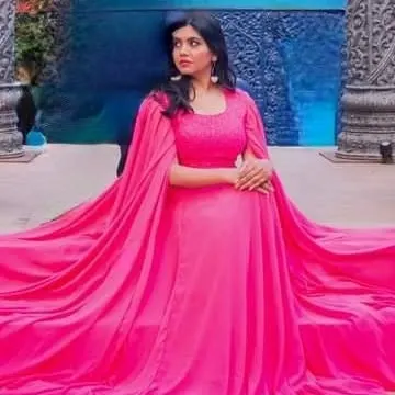 A fashion-forward look featuring a pink gown with an attached cape. I love creating unique and memorable styles for my clients' photoshoots.