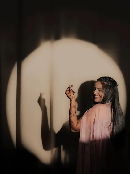 A playful shot of a bride and her shadow. Her smile and the beautiful mehandi create a moment of pure joy.