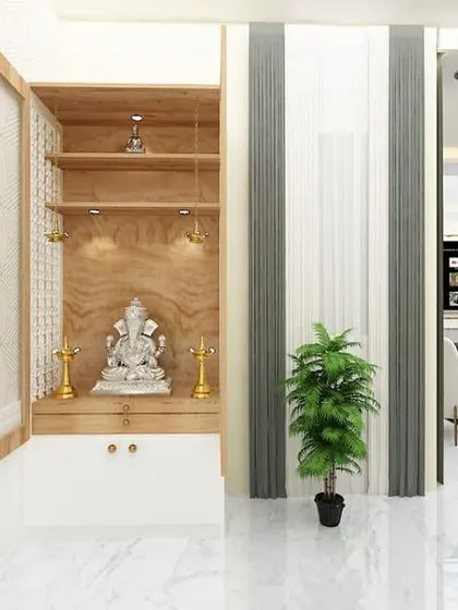 A beautifully crafted pooja unit with wooden cabinetry and intricate jali-work doors. The warm interior lighting highlights the Ganesha idol, creating a serene and divine focal point.