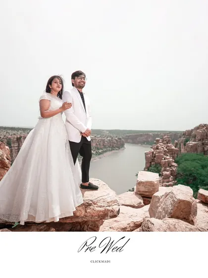 An epic pre-wedding photograph capturing the couple against the dramatic landscape of the Gandikota canyon, perfect for adventurous couples.
