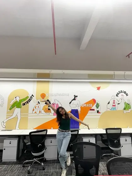 A fun shot of me in a corporate office after completing a long wall mural illustrating the company's values. The bigger the canvas, the bigger my smile!