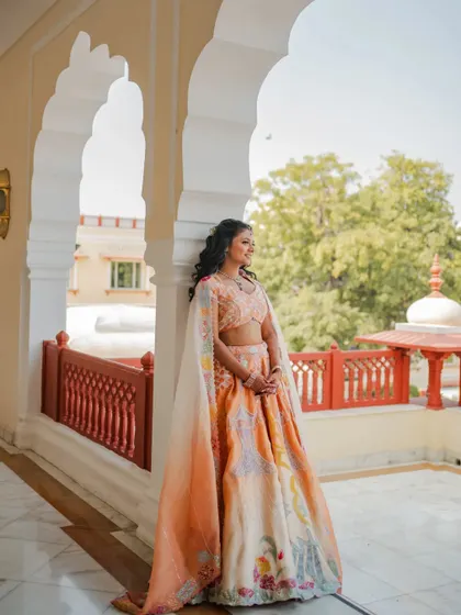 A stunning solo portrait of the bride-to-be, Radhika. I captured her against the beautiful arches of the Rajasthani palace, her cape lehenga adding a touch of modern elegance.