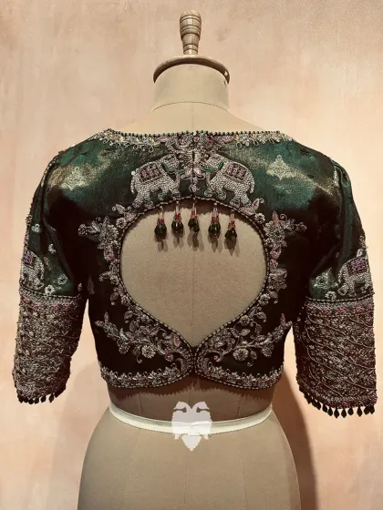 The striking back of the Eden green blouse, with an elegant cutout framed by ornate embroidery.