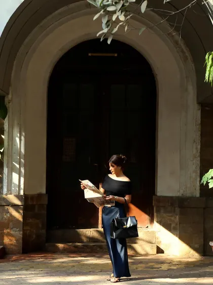 A candid-style shot of the model reading a map, creating a narrative for the campaign and making it more than just a fashion photo.