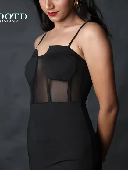 A close-up shot focusing on the mesh corset detail of the dress. This highlights the unique design features that make the product stand out.
