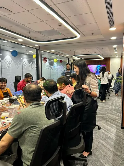 A wide shot of a corporate workshop in full swing. The room is buzzing with creative energy.