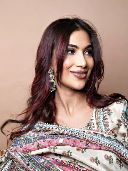 A profile shot that captures the richness and shine of the custom red hair color, achieved with L'Oréal's Majirel products.