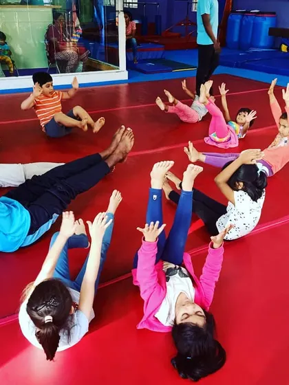 Our "Good Friends" class participating in the "Number Tumblers" theme. These images show the group learning advanced math and tumbling skills through warm-ups, stretches, and games.