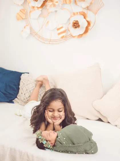 The look of wonder and love on a big sister's face. Our boho studio setup provides a warm and comfortable space for these delicate newborn photoshoots.