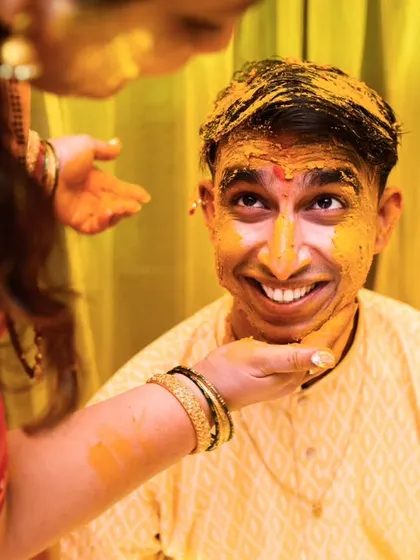 The groom's priceless expression as he gets covered in haldi. These are the funny memories that will be cherished for years.