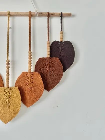 A close-up of the brown-toned macrame leaves, showing the different shades.