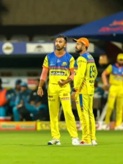Aditya Mani strategizing with a teammate during a Maharaja Trophy match. We teach our players to be smart, thinking cricketers on the field.