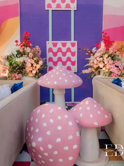Fantasy comes to life with these oversized, polka-dotted mushrooms nestled between seating areas. These props added a touch of Alice in Wonderland surrealism to the carnival atmosphere.