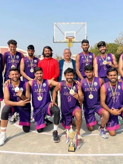 Celebrating a hard-fought victory. Our university basketball team proudly displays their medals and trophy after securing second place in an All India University tournament.