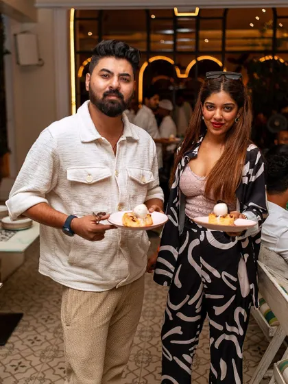 Guests holding plates of dessert, ready to indulge. Every course of your event menu is designed to be a delightful experience.