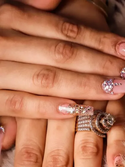 Another angle of this luxurious, crystal-heavy nail art design. The placement of each stone is carefully considered to catch the light beautifully, ensuring your hands are the center of attention.