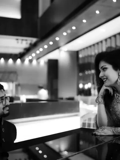 A quiet conversation between the couple during their engagement party. This candid black and white photo captures the natural interaction and bond they share.
