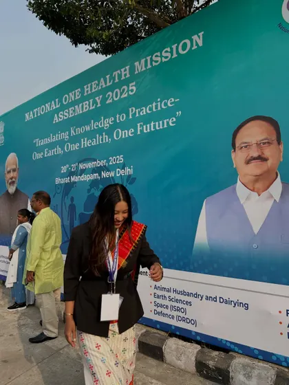 A candid moment during the conference, walking past the official event banner.