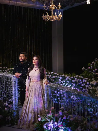 A grand, cinematic shot of the couple against their stunning decor. Mahima's makeup is polished and impactful, ensuring she looks like the star of the show.