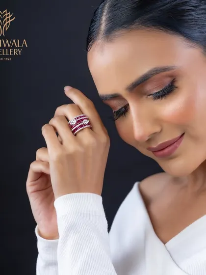 A statement of bold elegance, this ring features channels of rich rubies set between rows of brilliant diamonds. The design is both modern and powerful, crafted for a confident woman.