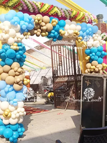 A simple yet beautiful balloon arch in blue, brown, and white marks the entrance to the baby welcome celebration.