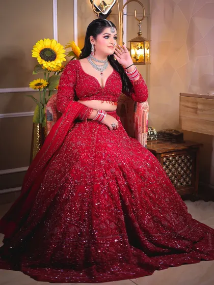 A seated portrait that allows the magnificent trail of the lehenga to be displayed.