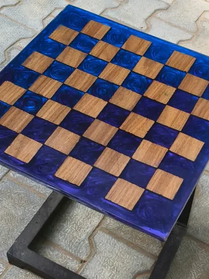 A functional piece for game lovers. This custom chess board table was made by setting wooden squares into a deep blue, swirling resin base.