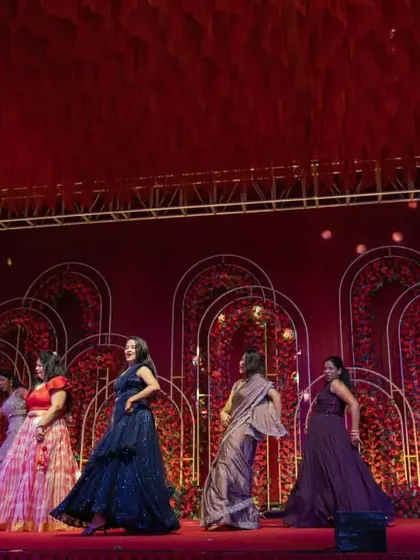 Bridesmaids performing a choreographed dance on the professionally set up stage at the Sangeet.
