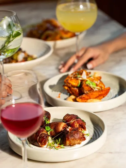 My Apero Hour features a selection of European-inspired tapas, like these chorizo-filled dates wrapped in bacon. They are the perfect salty-sweet bite.