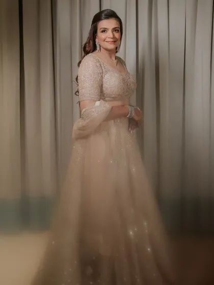 A full-length portrait of the bride-to-be, Vrinda, at her engagement. The motion blur on her lehenga adds a dreamy, magical quality.