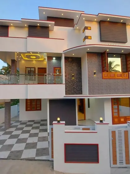 A spacious residential design featuring multiple balconies and a distinctive curved element on the facade. The combination of white walls, grey stone cladding, and wood-paneled window shutters gives the home a unique and inviting character.