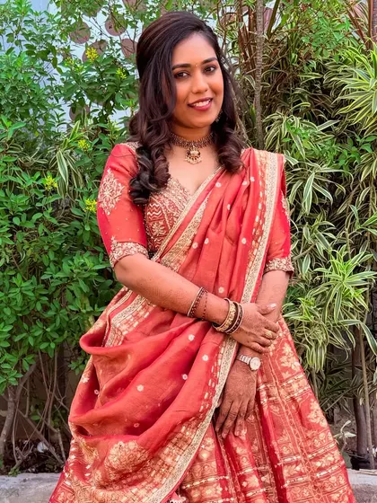 This outdoor shot shows how the makeup looks in natural evening light. The client's skin appears luminous, and the colors of her makeup and outfit are rich and vibrant.