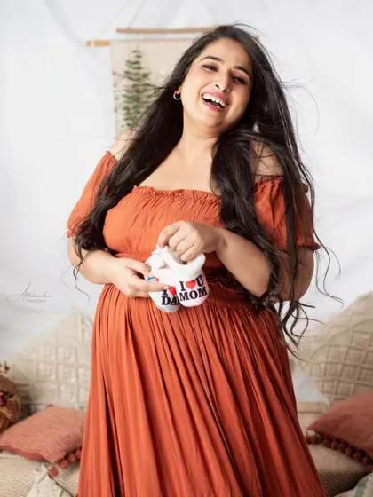 A joyful, candid shot of the mom-to-be. Her laughter is infectious, and it's these genuine moments we love to capture.