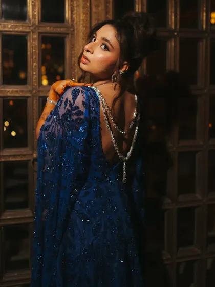 The back of Shree's sangeet gown, featuring a delicate, draped diamond necklace that adds a layer of sophistication and highlights the open-back design.
