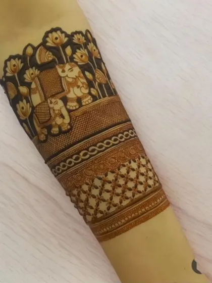 An elegant armband design featuring elephants amidst lotus flowers. This is a beautiful piece of traditional art, perfect for a bride or for festive occasions.