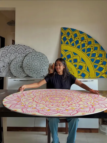The creator and her creations. A proud moment with a collection of recently completed mandala boards in various colors and styles, ready to be shipped out.