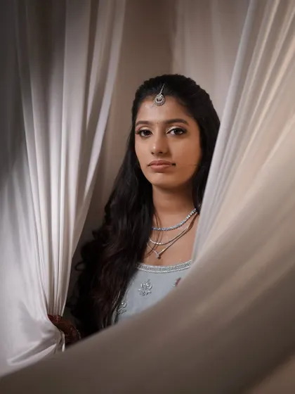 An artistic portrait. The makeup features a subtle silver eyeliner to match the embellishments on the lehenga, showing my attention to detail.
