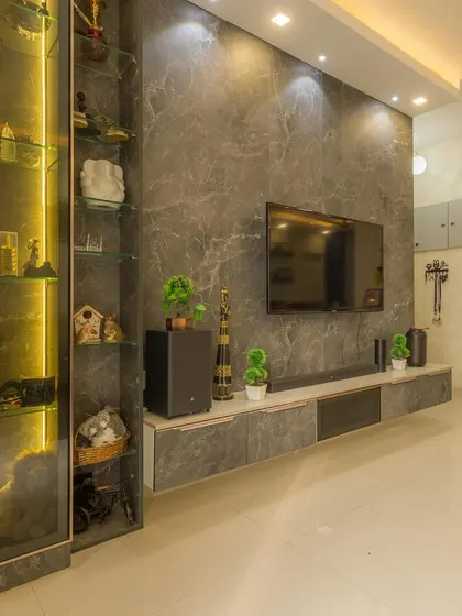 A tour of a beautifully designed home, starting with the living room's marble-finished entertainment wall and elegant, backlit shelving.