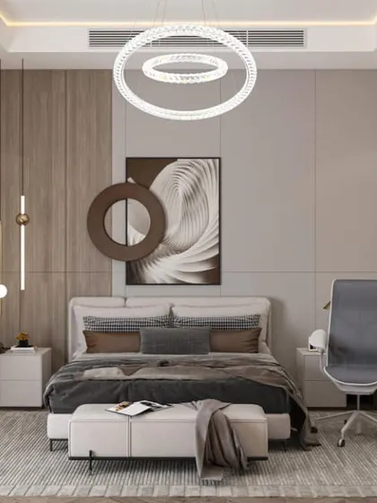 A contemporary bedroom design that includes a dedicated workspace. The room features a stylish circular chandelier, a mix of wood and grey tones, and modern art, making it perfect for a home office setup.