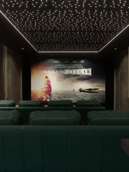 A luxurious lounge setup with deep green sofas and a starry ceiling. The back wall features a gallery of classic movie star portraits, adding a touch of old Hollywood glamour.