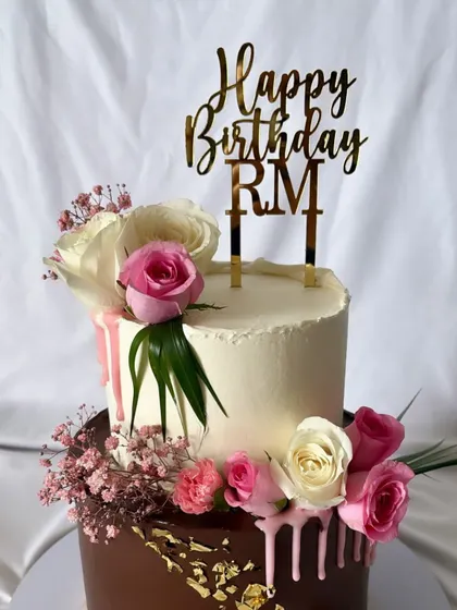 A simple and elegant "Happy Birthday RM" topper in gold mirror acrylic. This style is perfect for adding a personalized, sophisticated touch to any cake, like this beautiful one by a fellow baker.