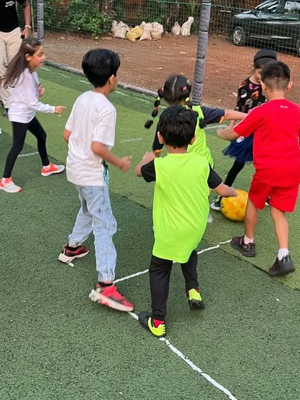 Teamwork makes the dream work, even at a birthday party! Kids huddle together during a game, learning to communicate and strategize while having fun.