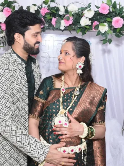 A candid look of love between the couple. These quiet, intimate moments amidst the celebration are truly precious.