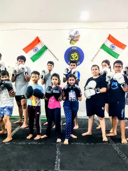 A moment of focus before the fun begins. This group of kids, a mix of boys and girls of all ages, is ready for their Muay Thai session, prepared to learn and grow together.