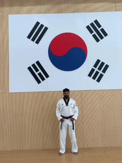 Standing in front of the South Korean flag at the Taekwondowon.