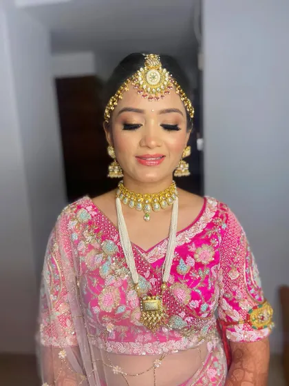 A close-up of Pooja's makeup, highlighting the flawless application and the beautiful pink tones on her eyes and lips.