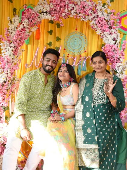 Another beautiful group shot of the couple with a family member at the Mehendi.